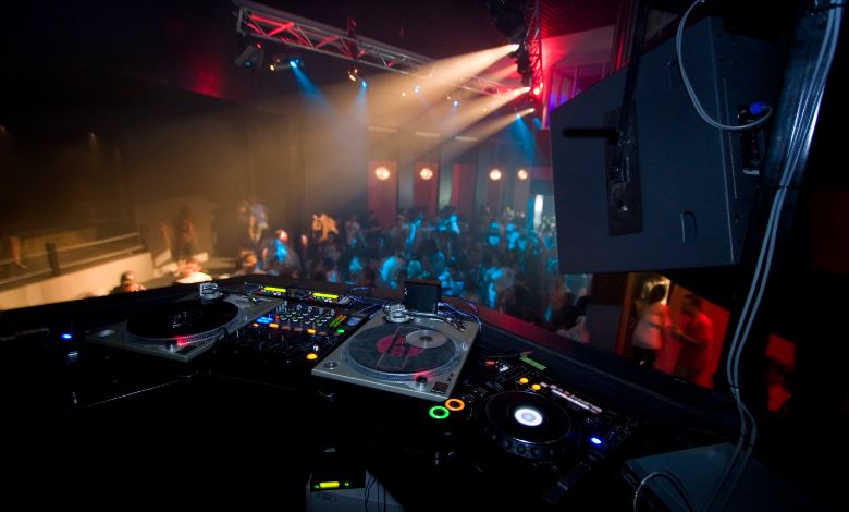 DJ spinning tracks at the booth overlooking a lively crowd in one of Amsterdam’s iconic night venues
