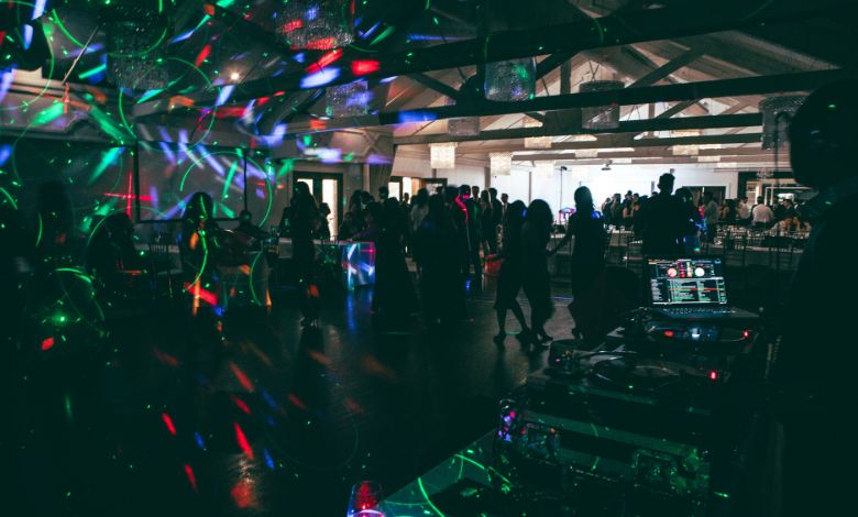 Dance floor with laser lights and DJ setup in a modern nightclub atmosphere