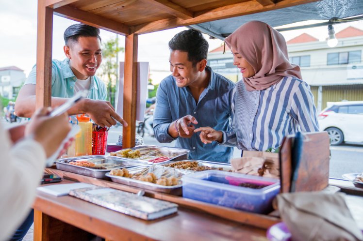 people eating in a food stall in dubai