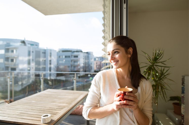 a women drinking tea peacefully in a balcony