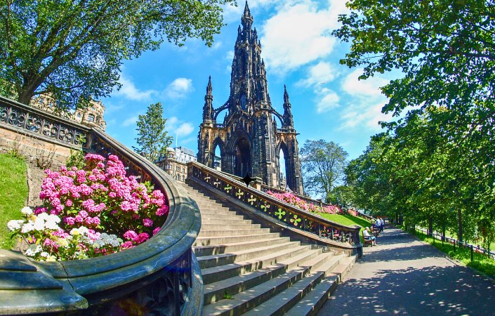 Scott Monument with flowers and stairs on a sunny day.