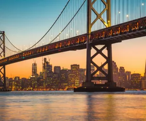 Bay Bridge San Francisco with city in the background at dusk.