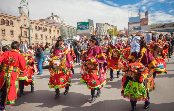 Traditional dancers in colorful cultural attire at Notting Hill Carnival parade.