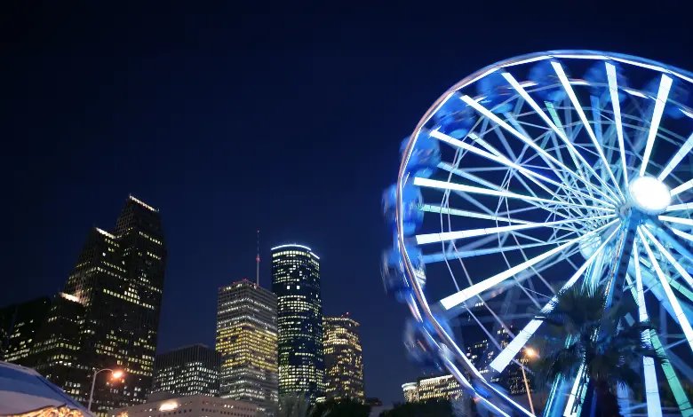 Houston skyline at night with illuminated Ferris wheel and downtown buildings