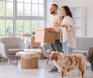 Couple moving into a new home with their dog