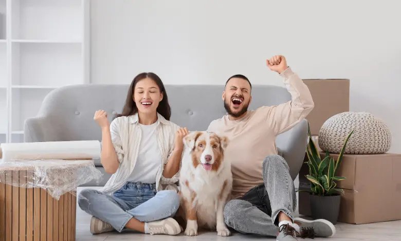 Couple relaxing with their pet in a new home after moving