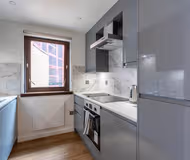Fully equipped kitchen at Stunning 1 Bed Merchant City Apartment with Parking