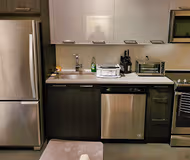 Fully equipped kitchen at </div>Furnished one bedroom with city views