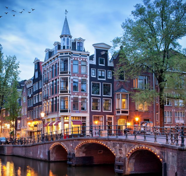 Amsterdam canal with old houses in Evening.