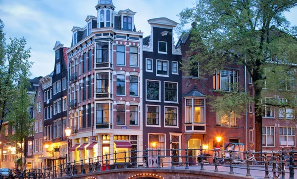 Amsterdam canal with old houses in Evening.
