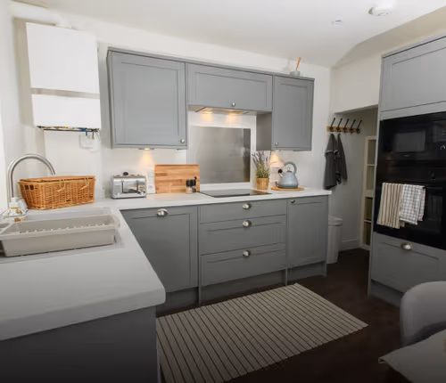 Fully equipped kitchen in Studio apartment at Stunning 2 Bedroom Home | Free Parking and Wifi