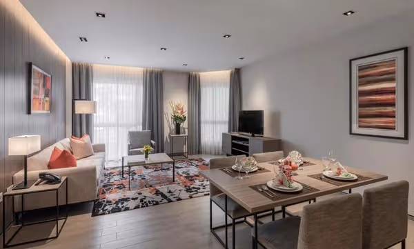 Modern serviced apartment living and dining area in Singapore with contemporary décor.