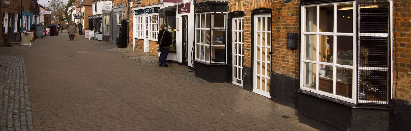 Stevenage Old Town high street with historic brick shopfronts.