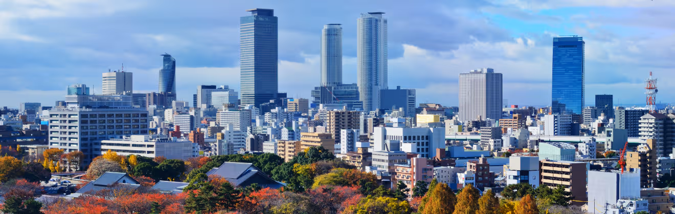 Nagoya city skyline with modern buildings and autumn trees