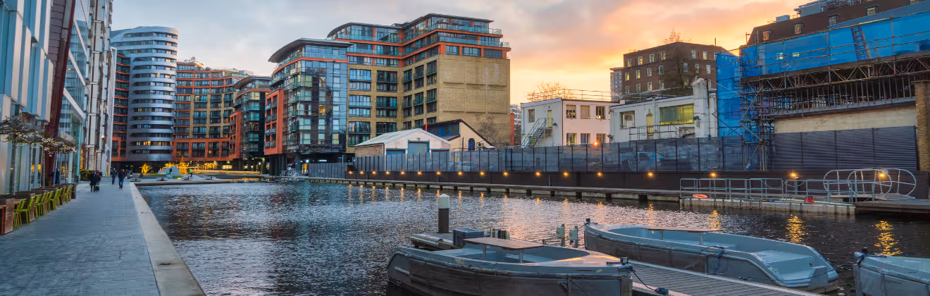 Modern red and glass apartment buildings at Paddington Basin at dusk