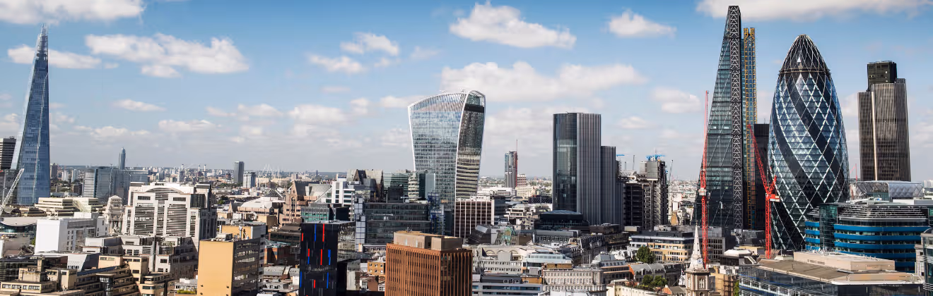 London skyline featuring the City of London with the Gherkin, Walkie Talkie, and modern skyscrapers.