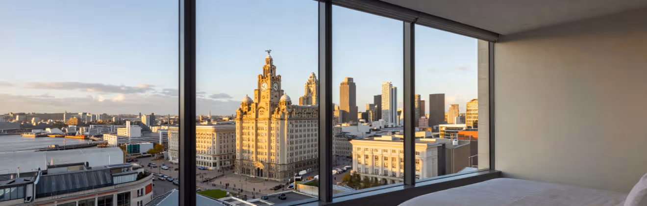 Liverpool's Royal Liver Building and waterfront skyline viewed from a bedroom apartment window
