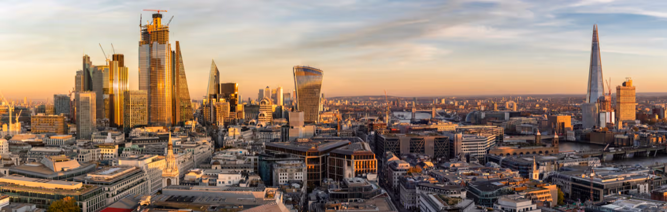 Aerial sunset view of the City of London skyline with Tower Bridge and modern skyscrapers