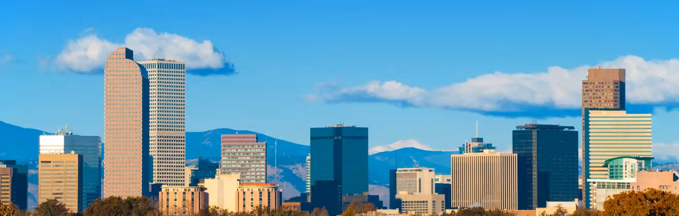 Denver skyline with mountains and city buildings near holiday apartments