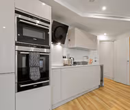 Fully equipped kitchen in 1 bed at Aldgate Apartment by MySquare