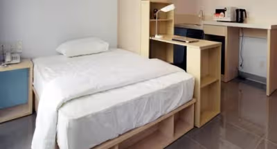 Simplistic living area in Yoshinocho Apartments