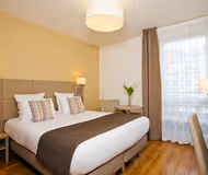 King sized bedroom at Monceau Bois Colombes Serviced Apartment, Champs Elysees