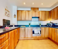 Fully equipped kitchen at Stylish Riverside Apartment with Parking