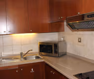 Fully equipped kitchen at Al Rawda Arjaan Serviced Apartments, Nahyan Camp